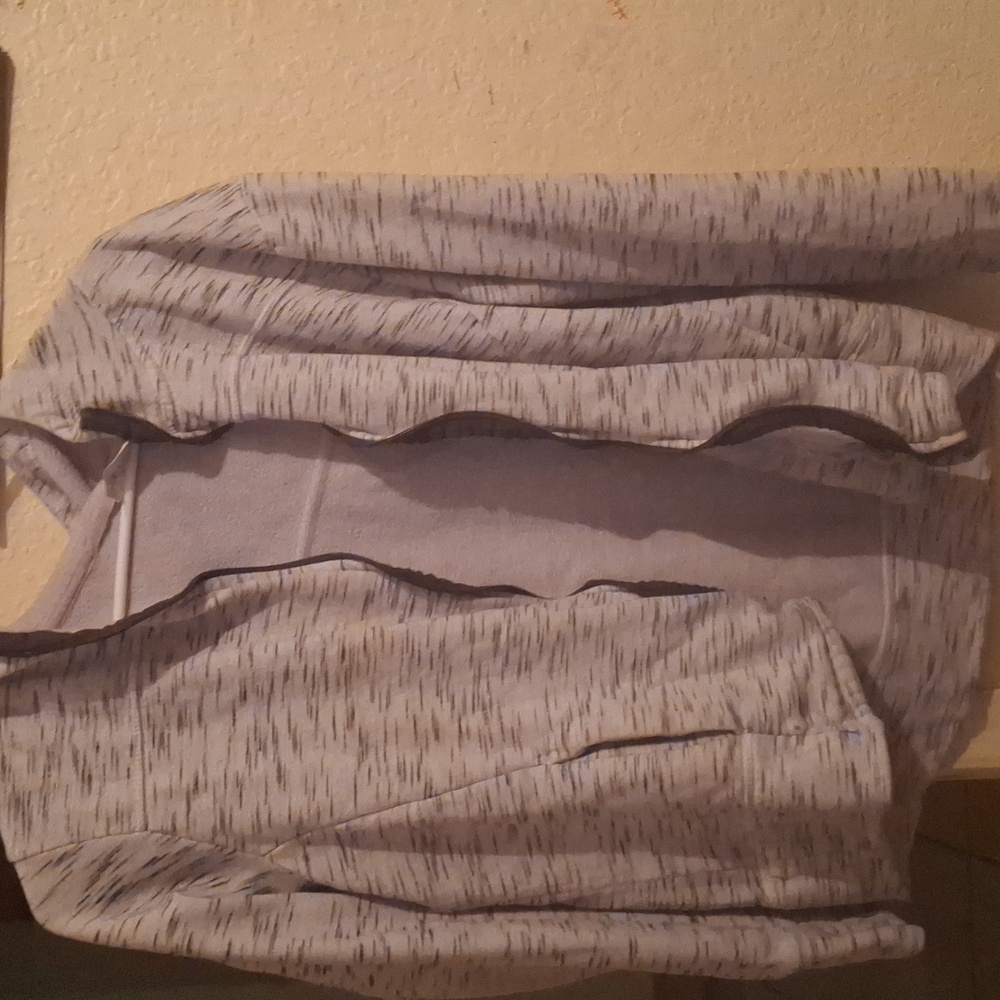 Gray zip-up jacket with hole in hood that has no zipper